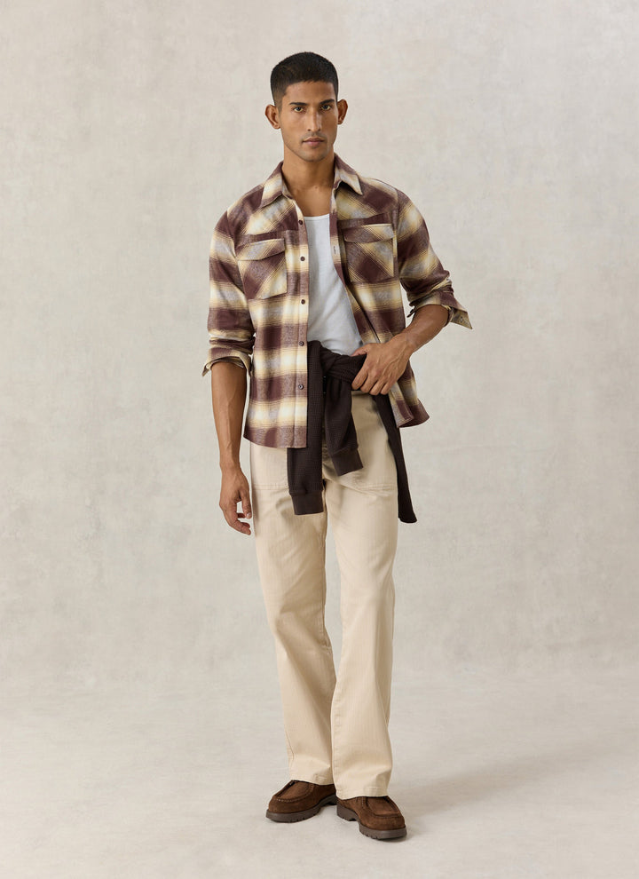 Percival Ashe check shirt worn open over a white tee