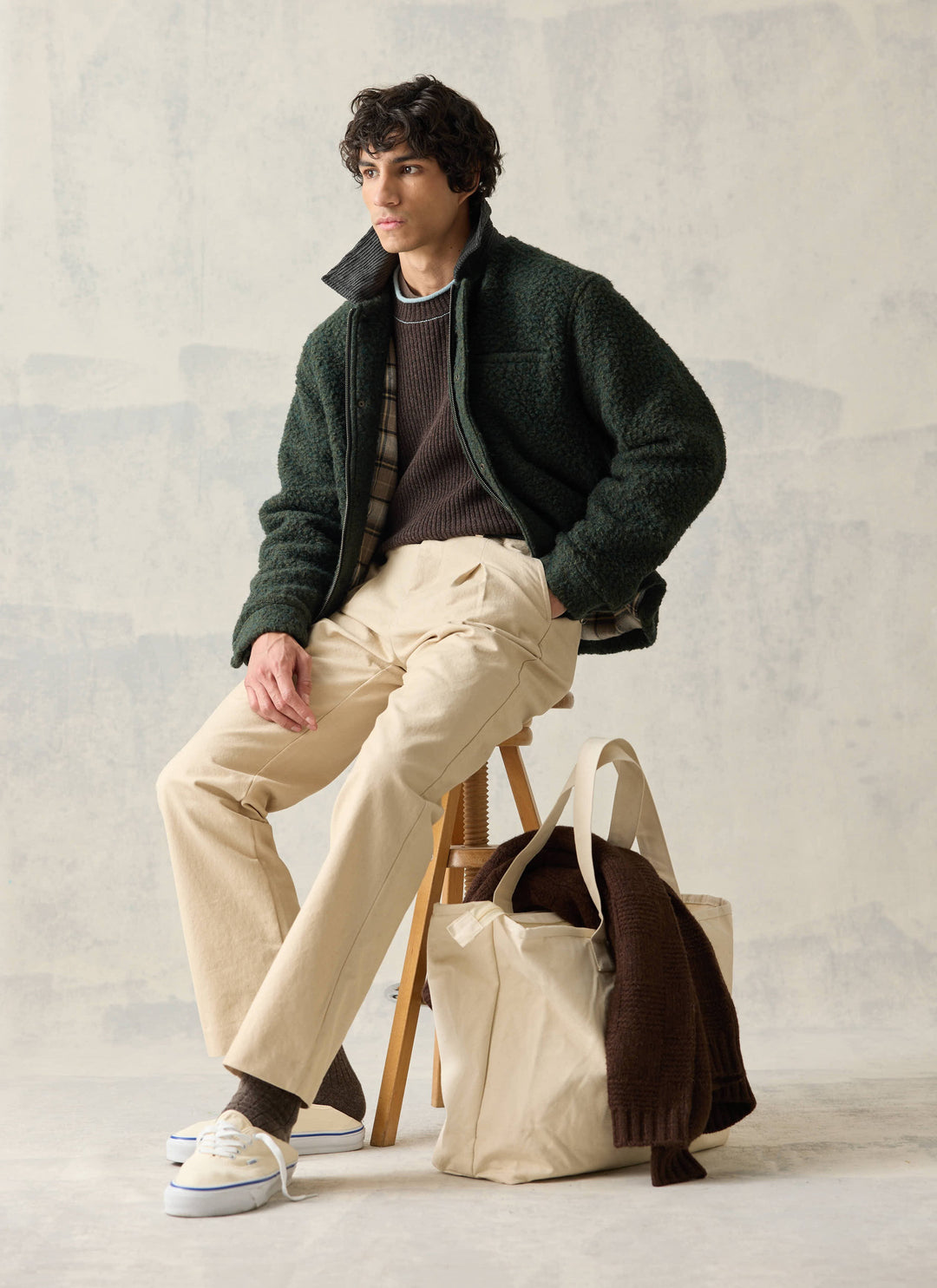 Percival Murrey forest green jacket seated